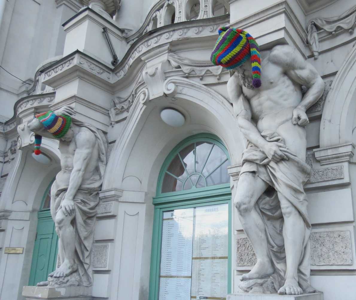 the sculptures at the front of the national theater Riga